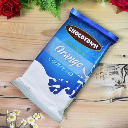 Wukusy Chocotown Premium Orange Compound 500g, a bright orange flavored confectionery ingredient for baking and desserts.