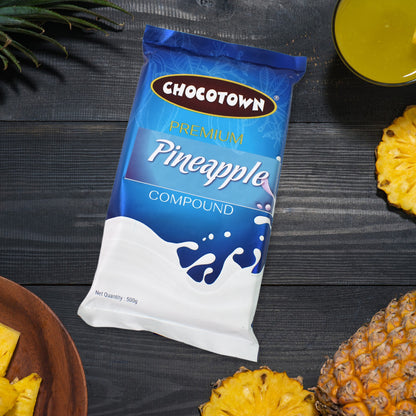 Wukusy Chocotown Premium Pineapple Compound in 500g container, creamy pineapple-flavored food product with a smooth texture.