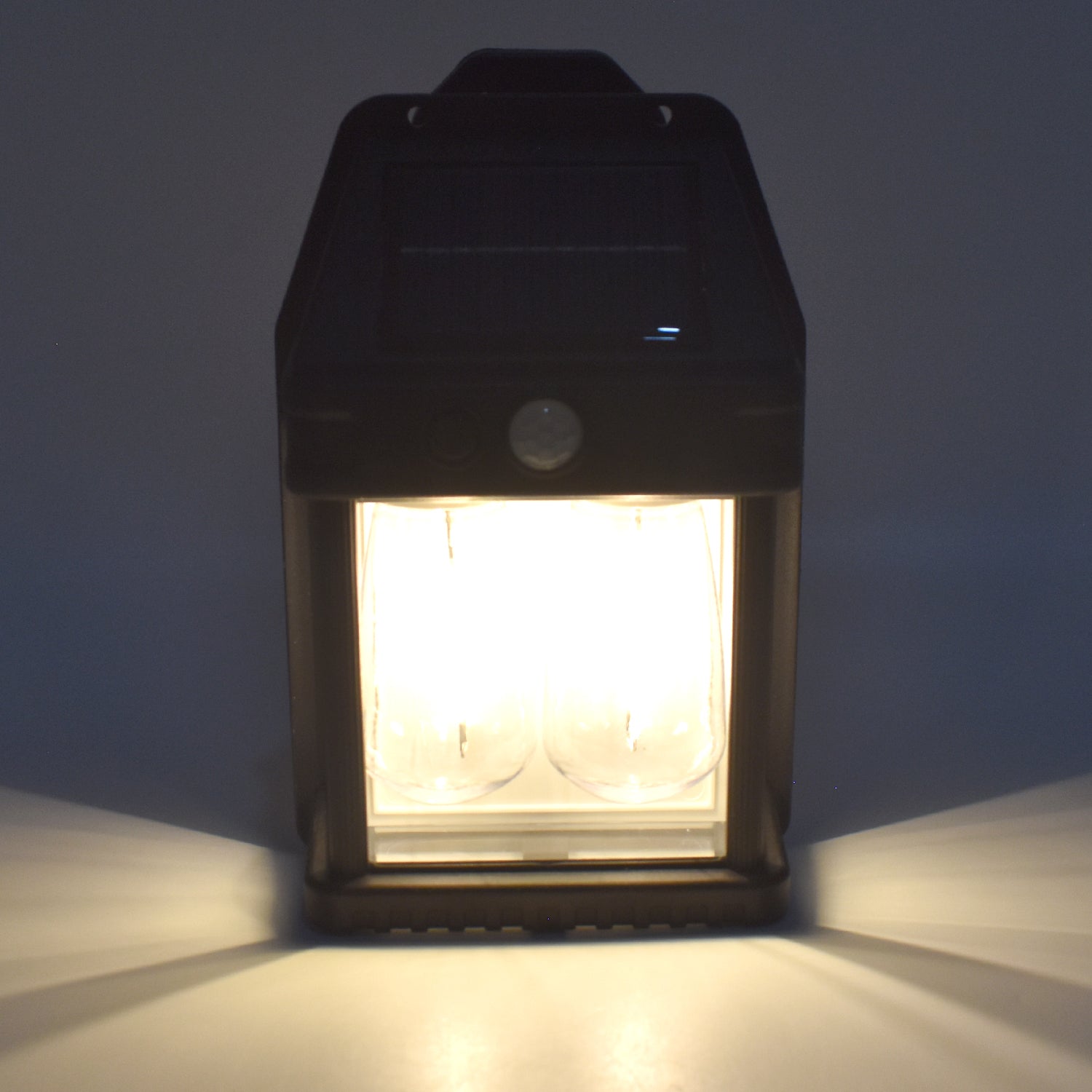 Wukusy 18W solar garden wall double lights with two modes and motion sensor, installed on a garden wall for outdoor lighting.