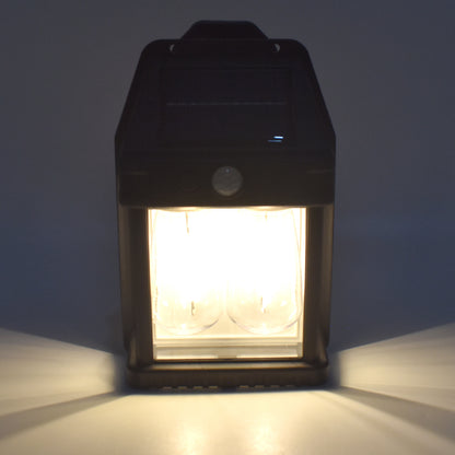 Wukusy 18W solar garden wall double lights with two modes and motion sensor, installed on a garden wall for outdoor lighting.