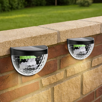 Wukusy garden solar-powered wall mount fence lights with honeycomb shade design, 6 LED lights in a 2-piece set.