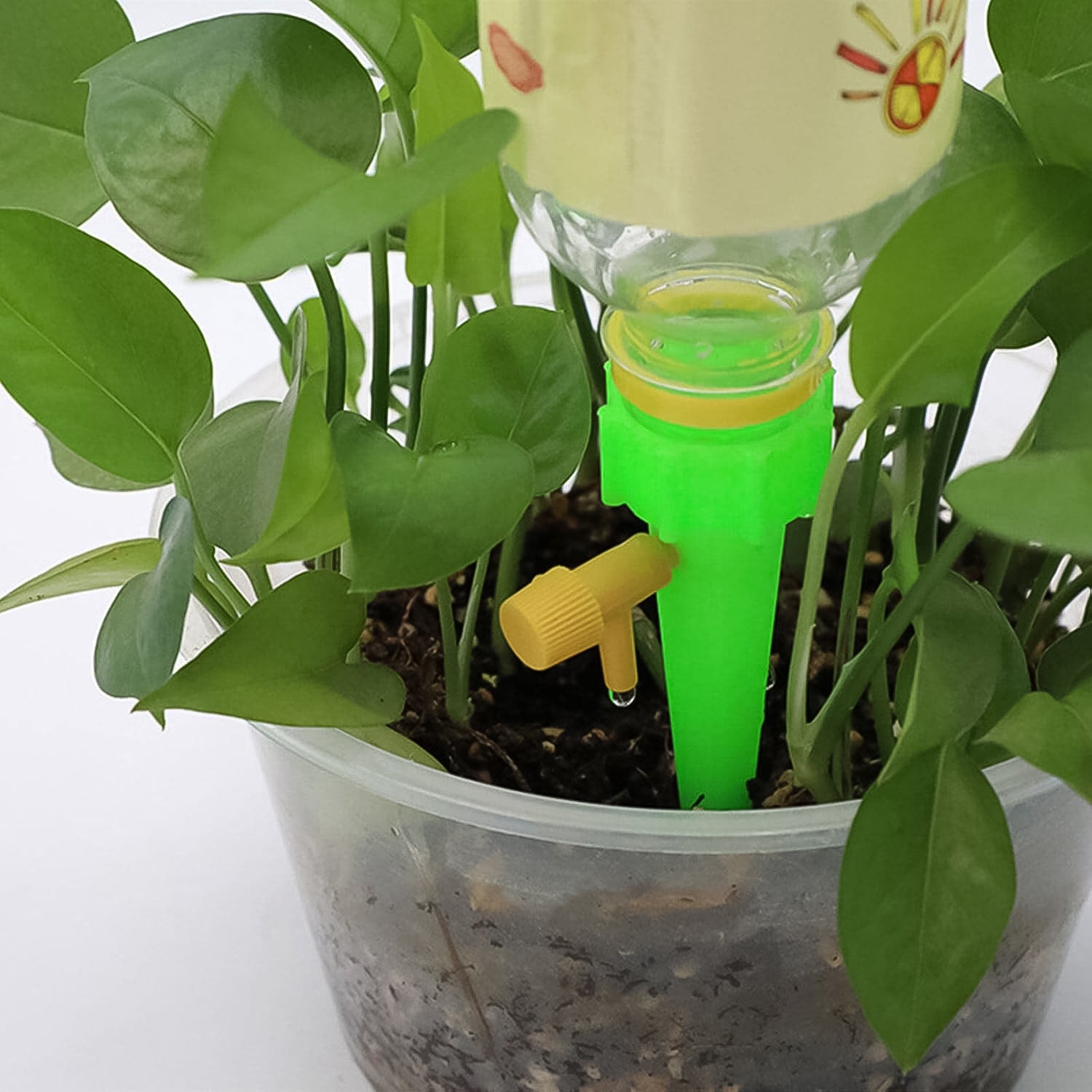 Green Wukusy garden self-watering plant spike for efficient watering of potted or garden plants.