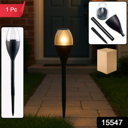 Wukusy solar-powered outdoor garden pathway light illuminating a garden path with a sleek black post and clear glass lantern.