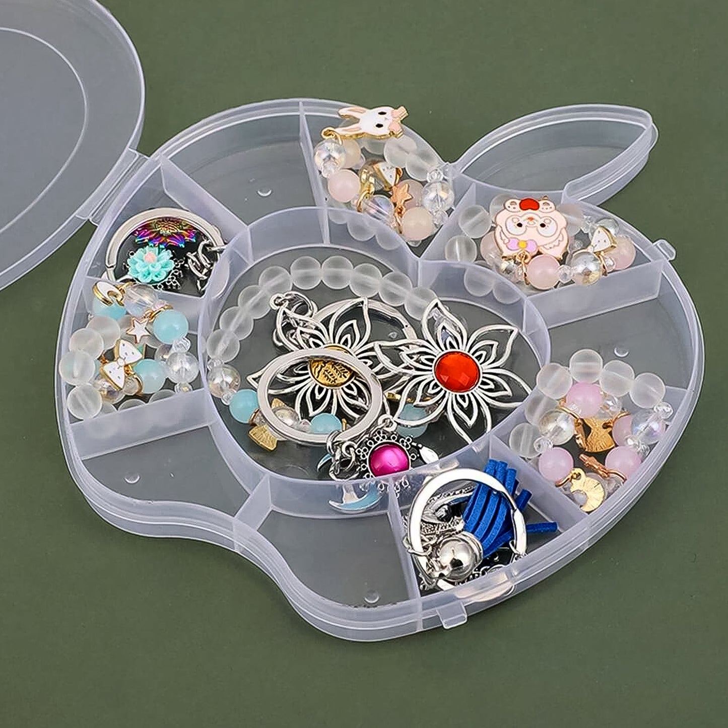Plastic apple-shaped jewelry storage box by Wukusy, compact health and beauty accessory for organizing rings and earrings.