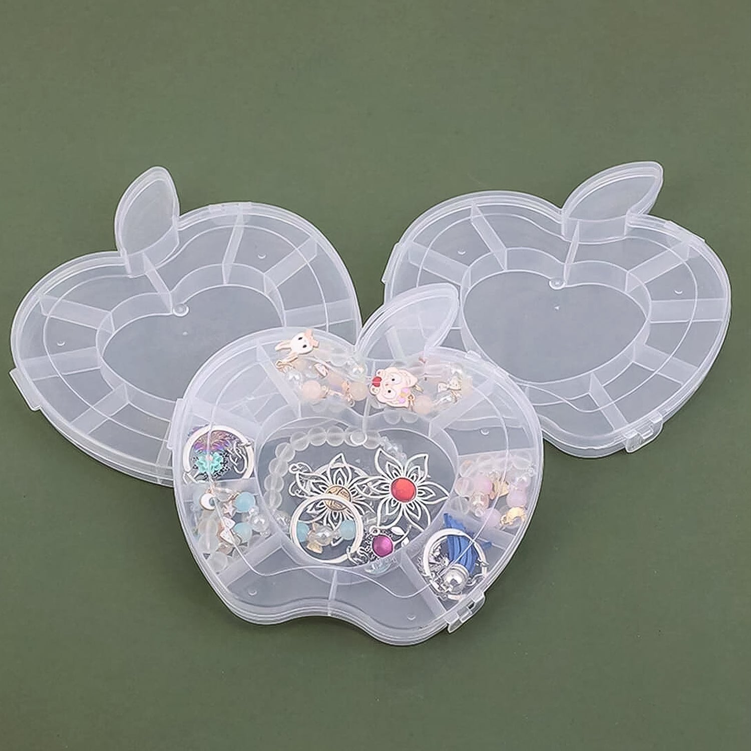 Plastic apple-shaped jewelry storage box by Wukusy, compact and colorful for organizing rings, earrings, and small accessories.