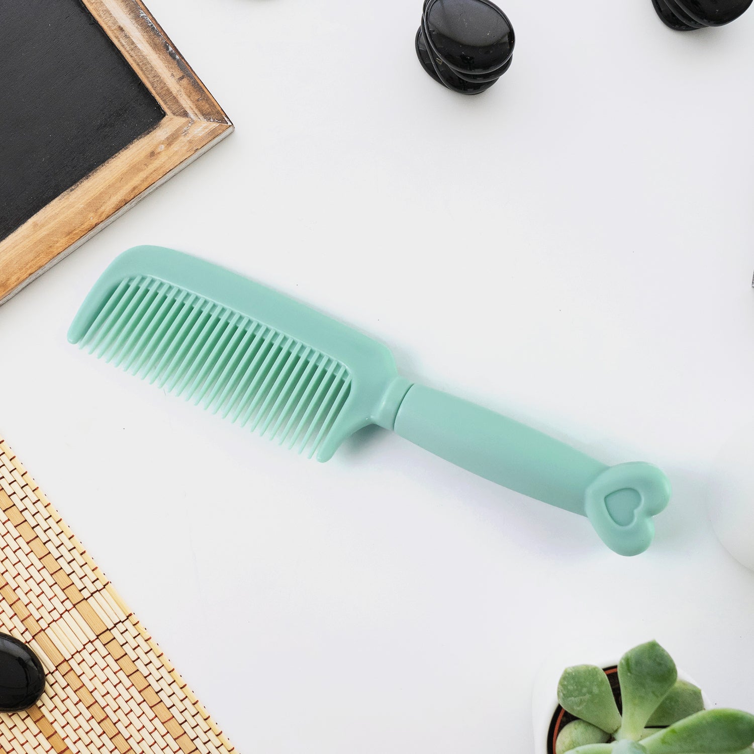Wukusy plastic hair comb with a heart-shaped handle, perfect for detangling and styling hair in a health and beauty routine.