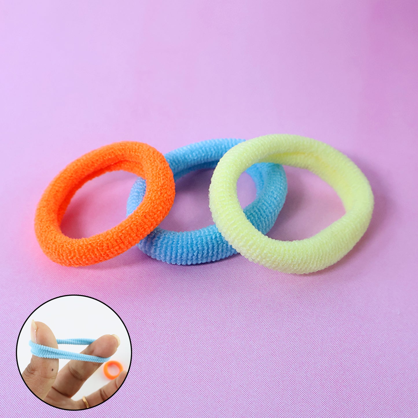 Set of three Wukusy seamless soft hair elastics, gentle and stretchy hair ties for everyday use, in a health and beauty product display.