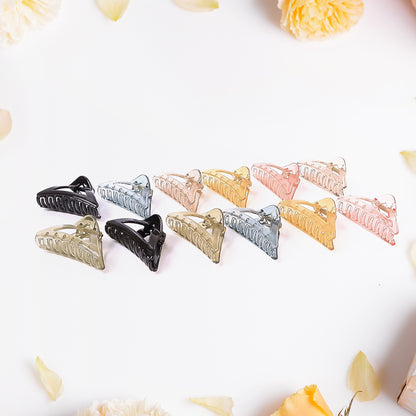 Set of 12 colorful triangle-shaped plastic hair claw clips by Wukusy, durable grip for women and girls.