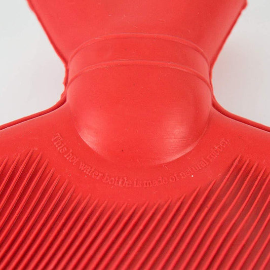 Medium Wukusy rubber hot water heating pad for pain relief, shown in a healthcare setting with a textured surface.