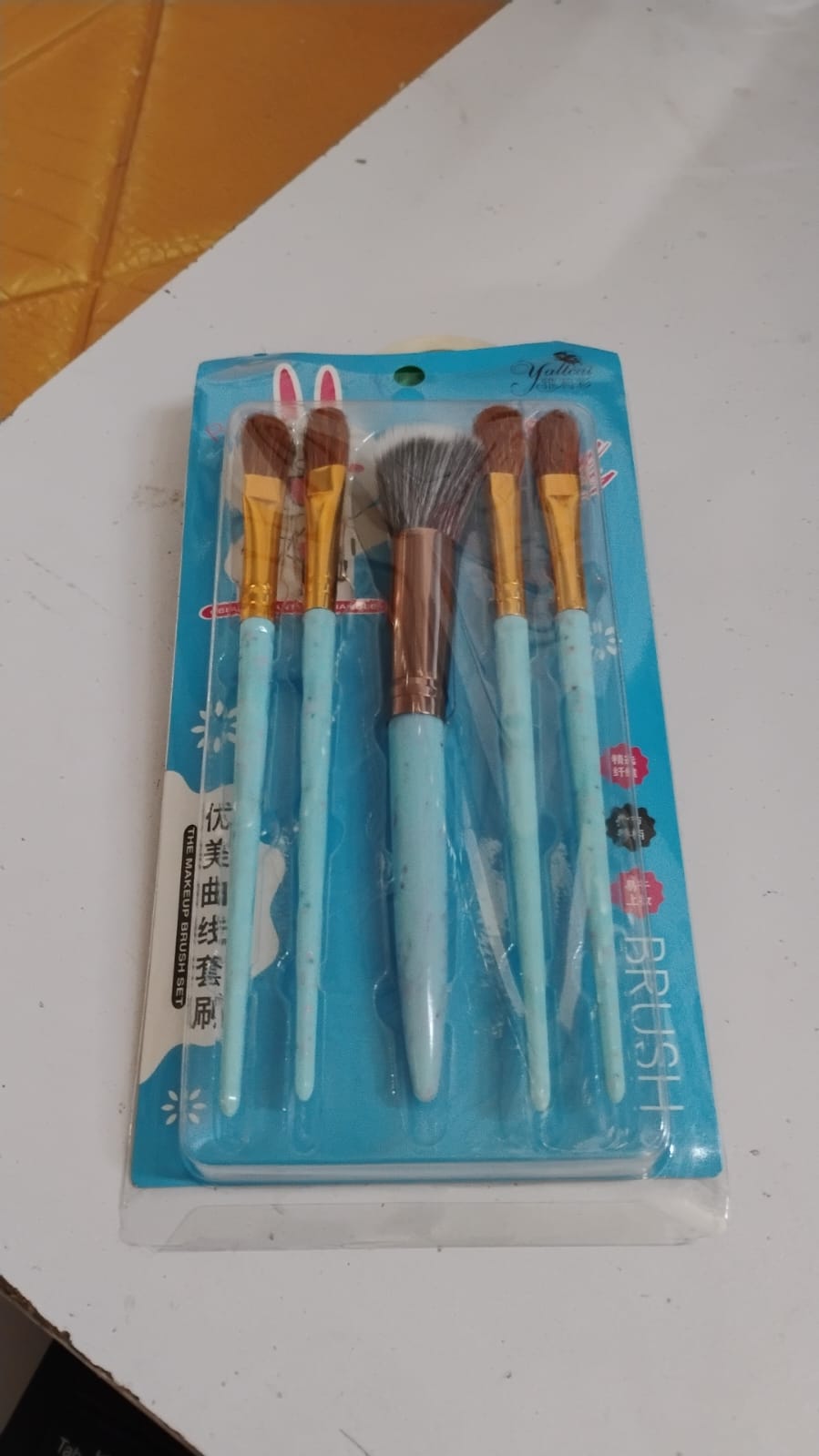 Wukusy 5-piece makeup brush tools kit with mixed color handles, including various brushes for applying makeup.