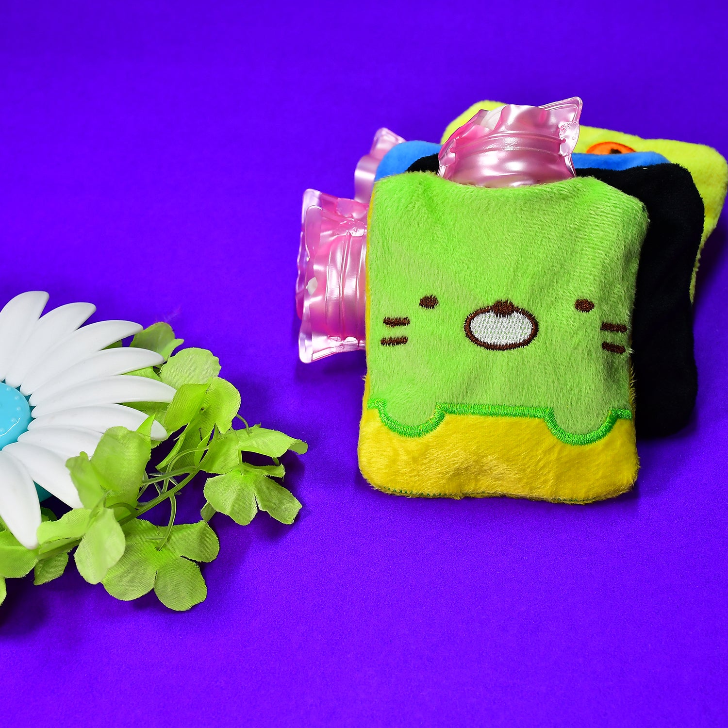Green Wukusy Kitty hot water bag with cover, used for pain relief, neck, shoulder, hand, foot warmth, and menstrual cramps.