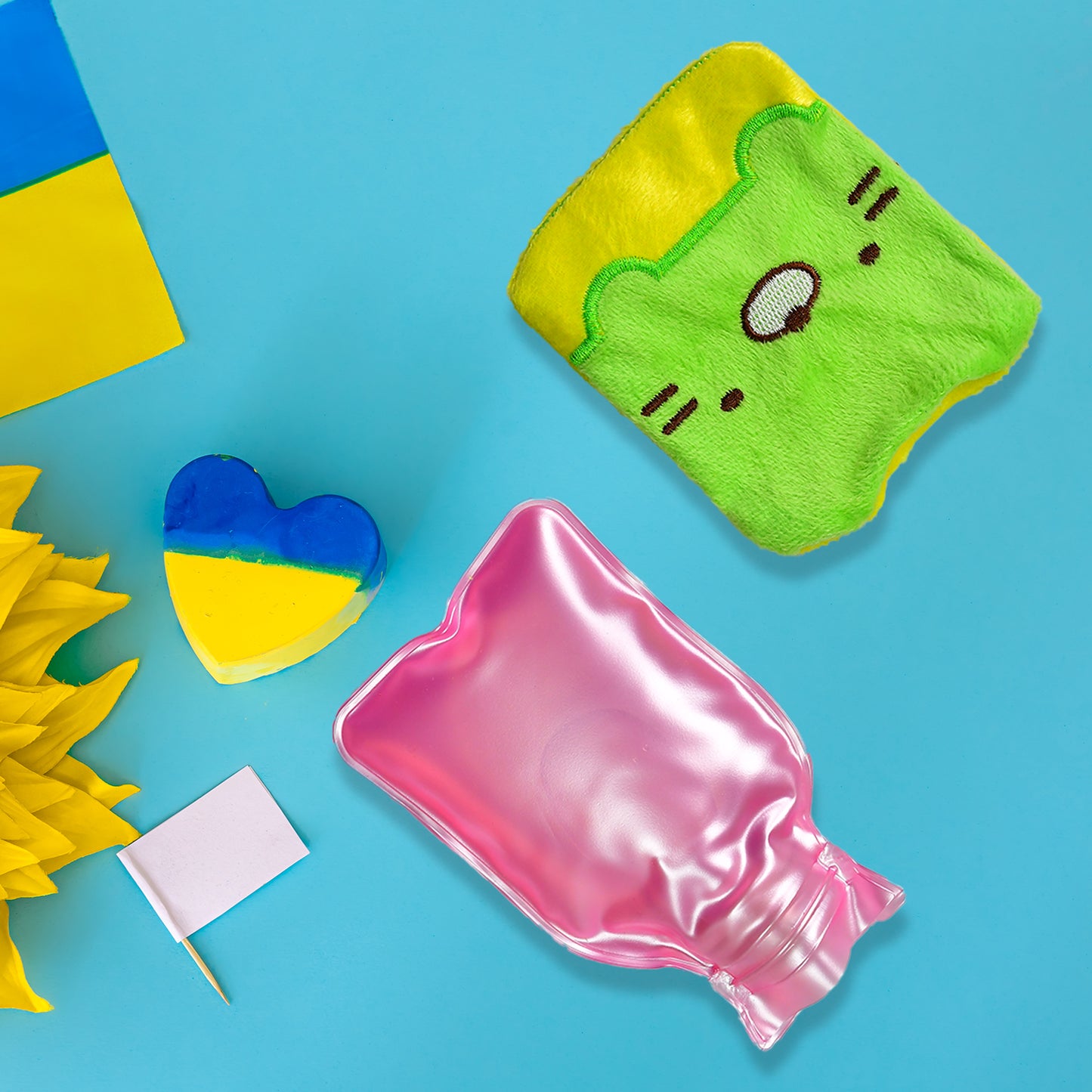 Green Wukusy kitty-shaped small hot water bag with cover, used for pain relief, neck, shoulder, hand, feet warmth, and menstrual cramps.