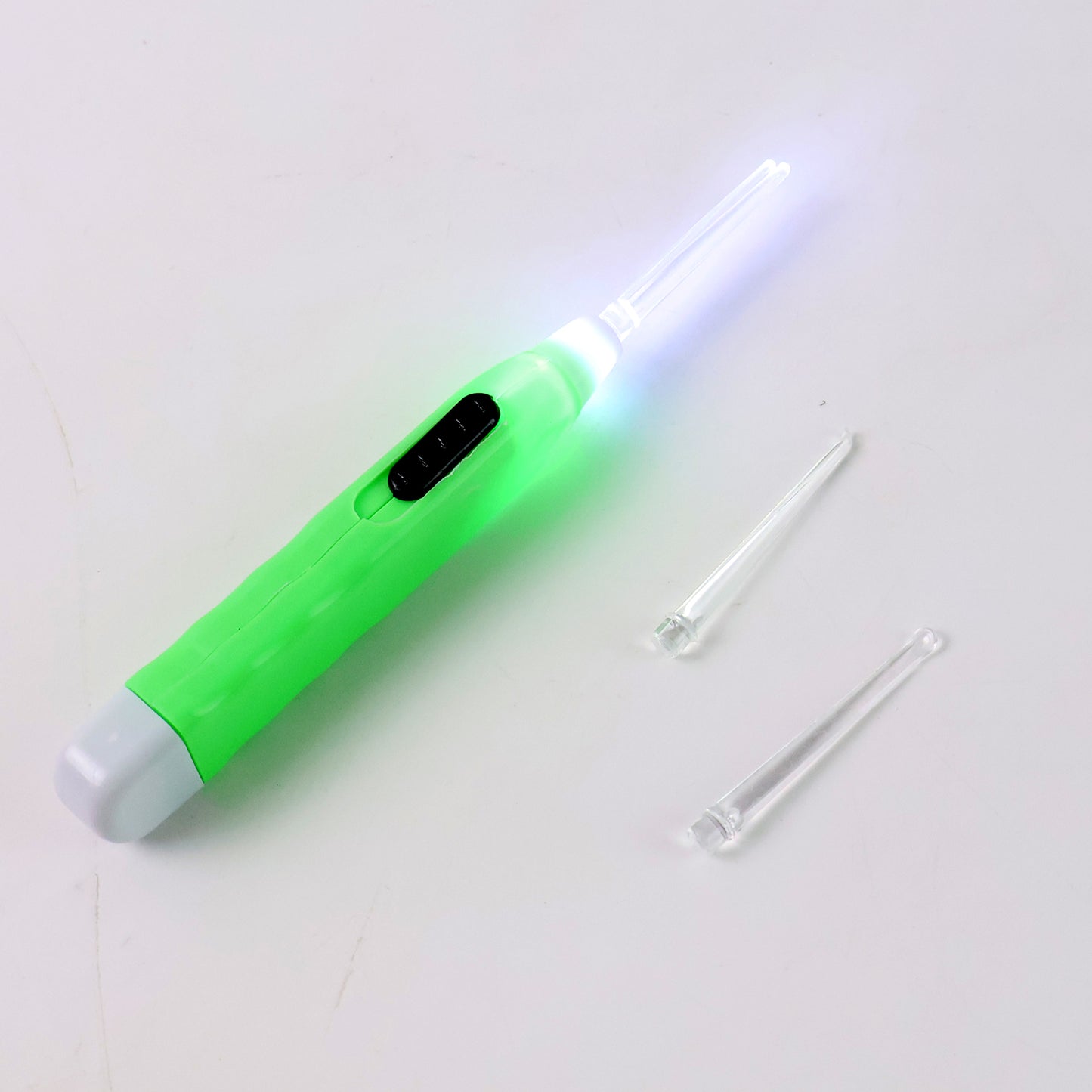 Green LED flashlight earpick with tweezers, Wukusy health care tool for ear cleaning, compact and portable.