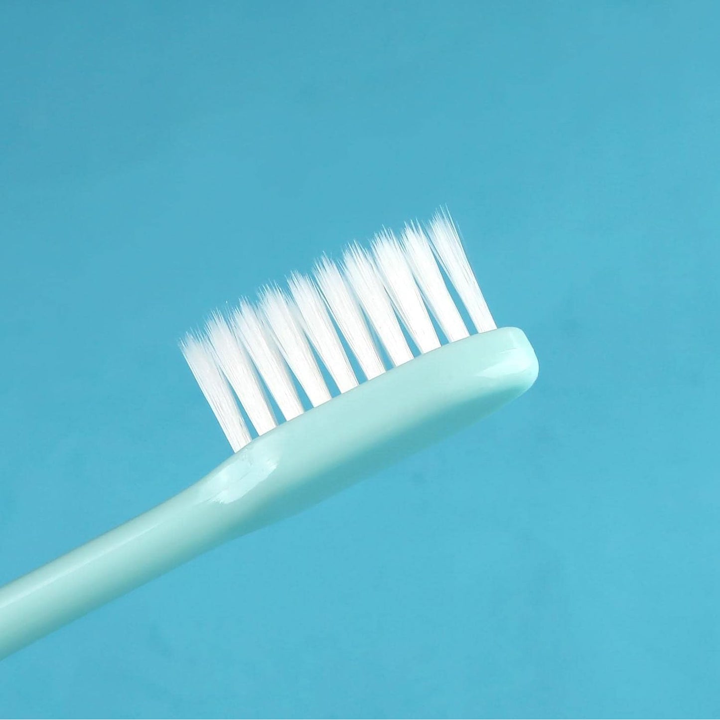 Set of 10 Wukusy kids and adults ultra-soft bristled toothbrushes with covers, ideal for gentle oral care and travel.