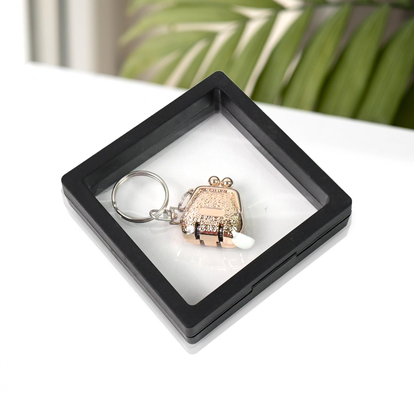 Wukusy health care nail clipper keychain with 3D floating frame display case, compact and portable grooming accessory.