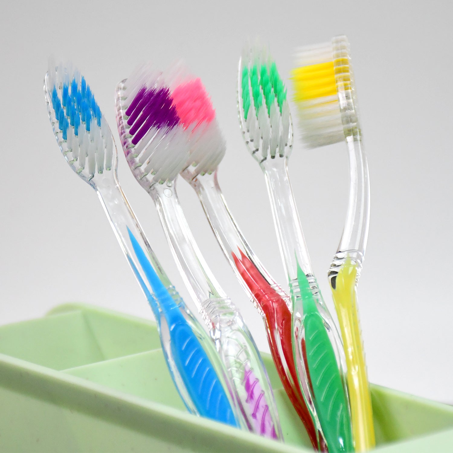Wukusy premium plastic toothbrush in mixed colors, designed for effective oral health care, with soft bristles for gentle cleaning.