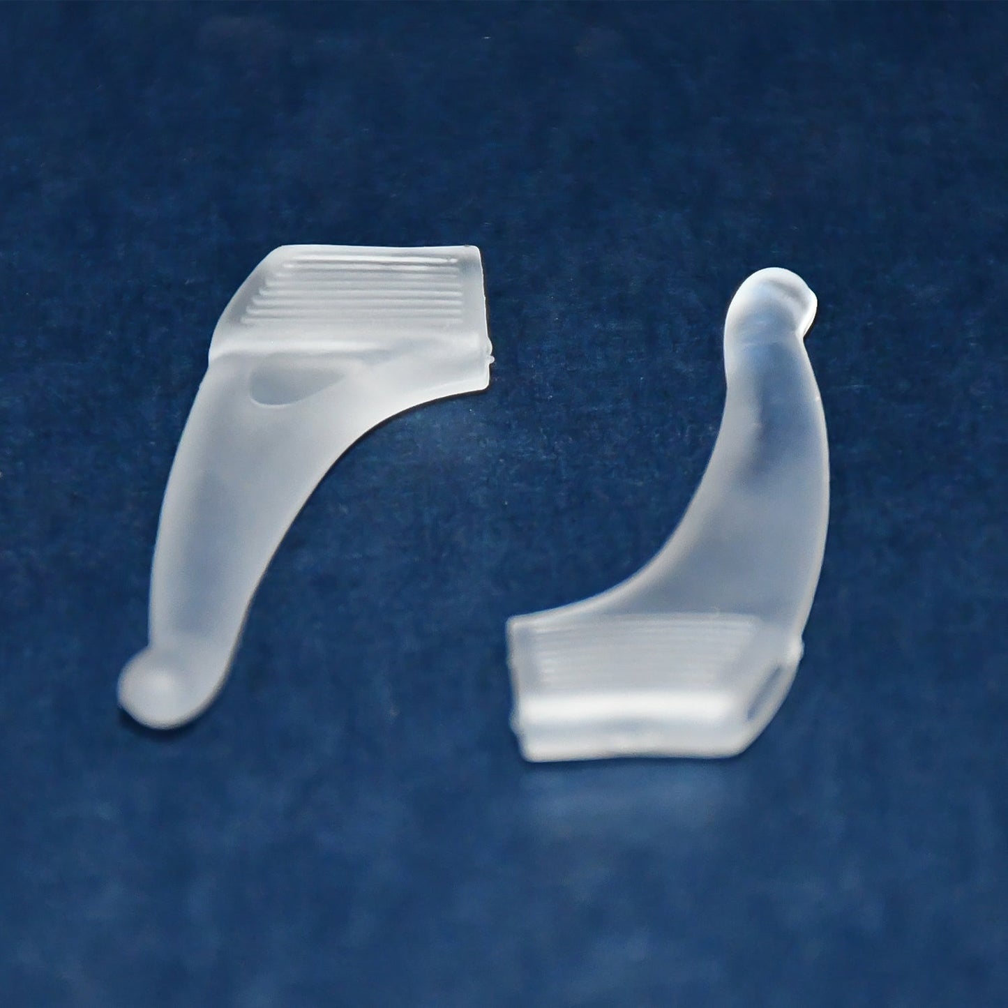 Pair of soft silicone glasses ear hooks by Wukusy, designed for anti-slip comfort on eyeglasses.