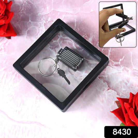 Wukusy suitcase shape nail clipper keychain with key in 3D floating frame display case, ideal for health care and grooming.