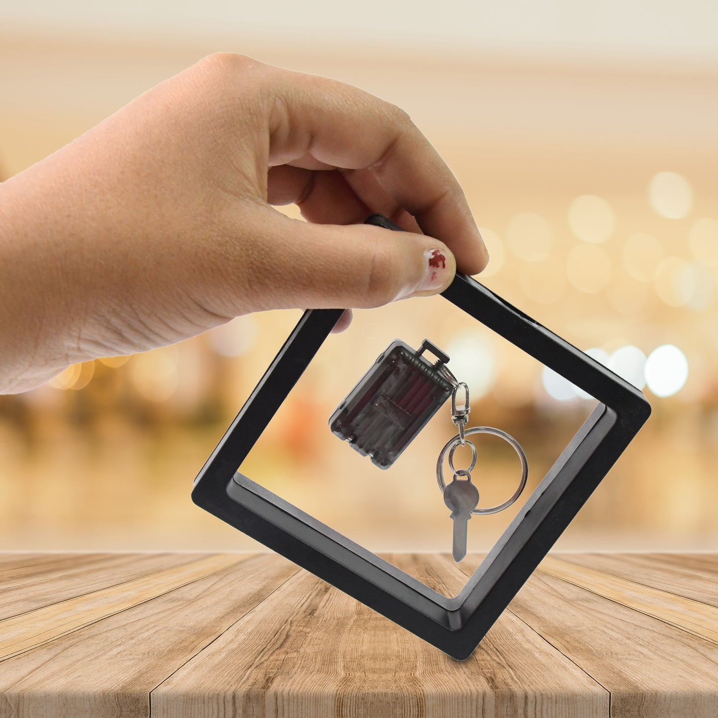 Wukusy suitcase-shaped nail clipper keychain with key, displayed in a 3D floating frame case, perfect for health care on the go.