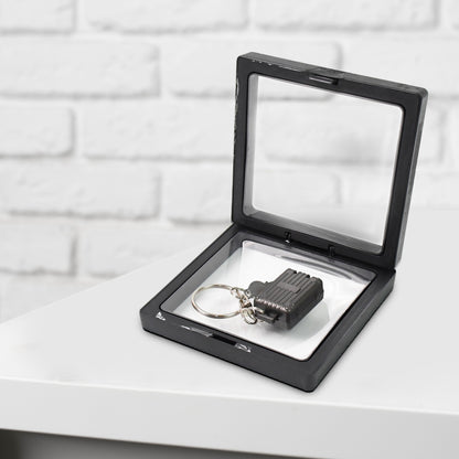 Wukusy suitcase-shaped nail clipper keychain with key in 3D floating frame display case, compact health care accessory.