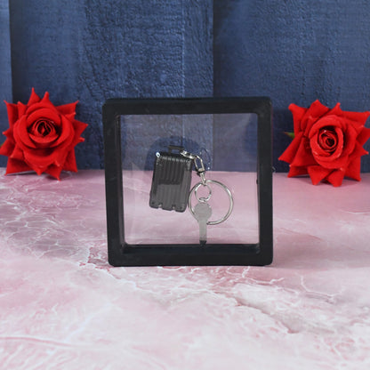 Wukusy suitcase-shaped nail clipper keychain with key in 3D floating frame display case, compact travel grooming accessory.