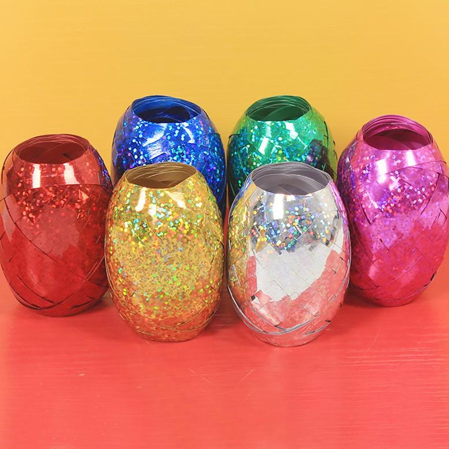Wukusy curling balloon ribbon roll for gifts, balloons, and crafts, featuring colorful, metallic curling ribbon for decorative projects.