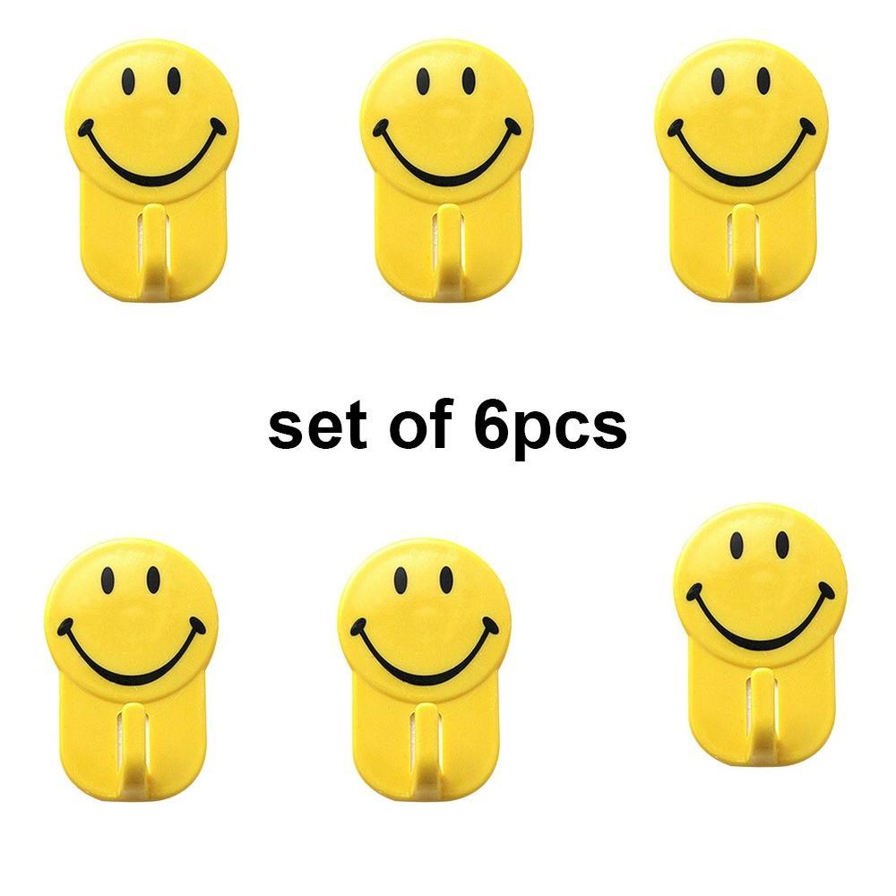 Set of six Wukusy plastic self-adhesive smiley face hooks, each with 1 kg load capacity, ideal for home decor and organization.