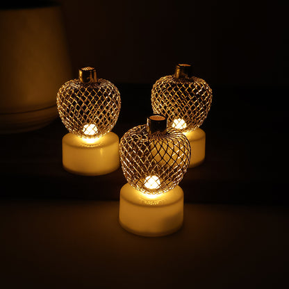 Set of 12 decorative apple-shaped LED tealight candles by Wukusy for home decor, with warm glowing light and realistic apple design.