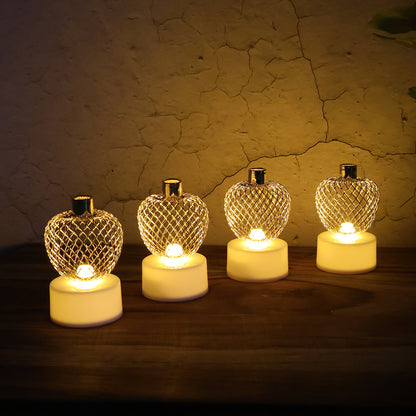 Set of four decorative apple-shaped LED tealight candles by Wukusy for home decor, featuring warm glowing lights.