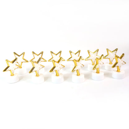 Set of 12 Wukusy star-shaped flameless LED candles for home decor, realistic flickering light, decorative indoor lighting.