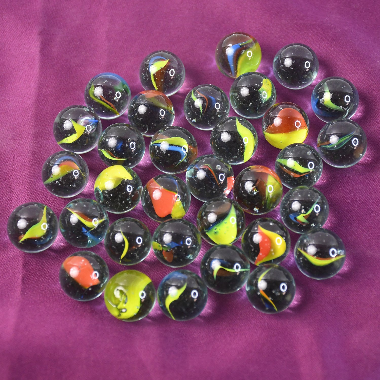 Set of 35 colorful glass marbles for kids, ideal for home decor or play, by Wukusy.