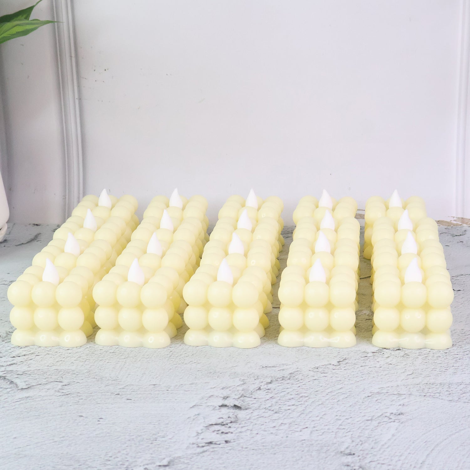Set of 24 Wukusy LED flameless cube decorative candles for home decor, featuring warm, realistic flickering light.