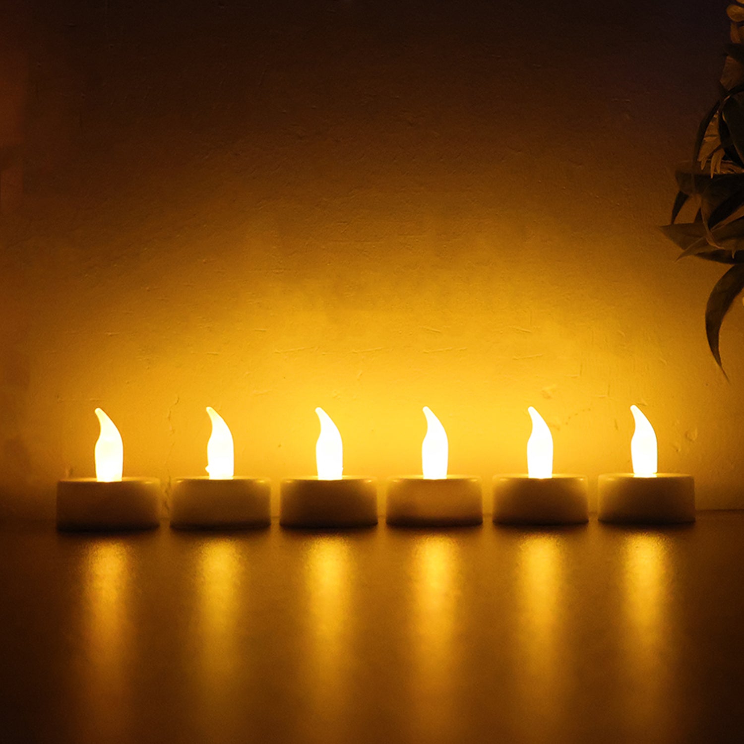 Six Wukusy LED flameless tealight candles for home decor, showcasing warm, flickering light in a cozy setting.