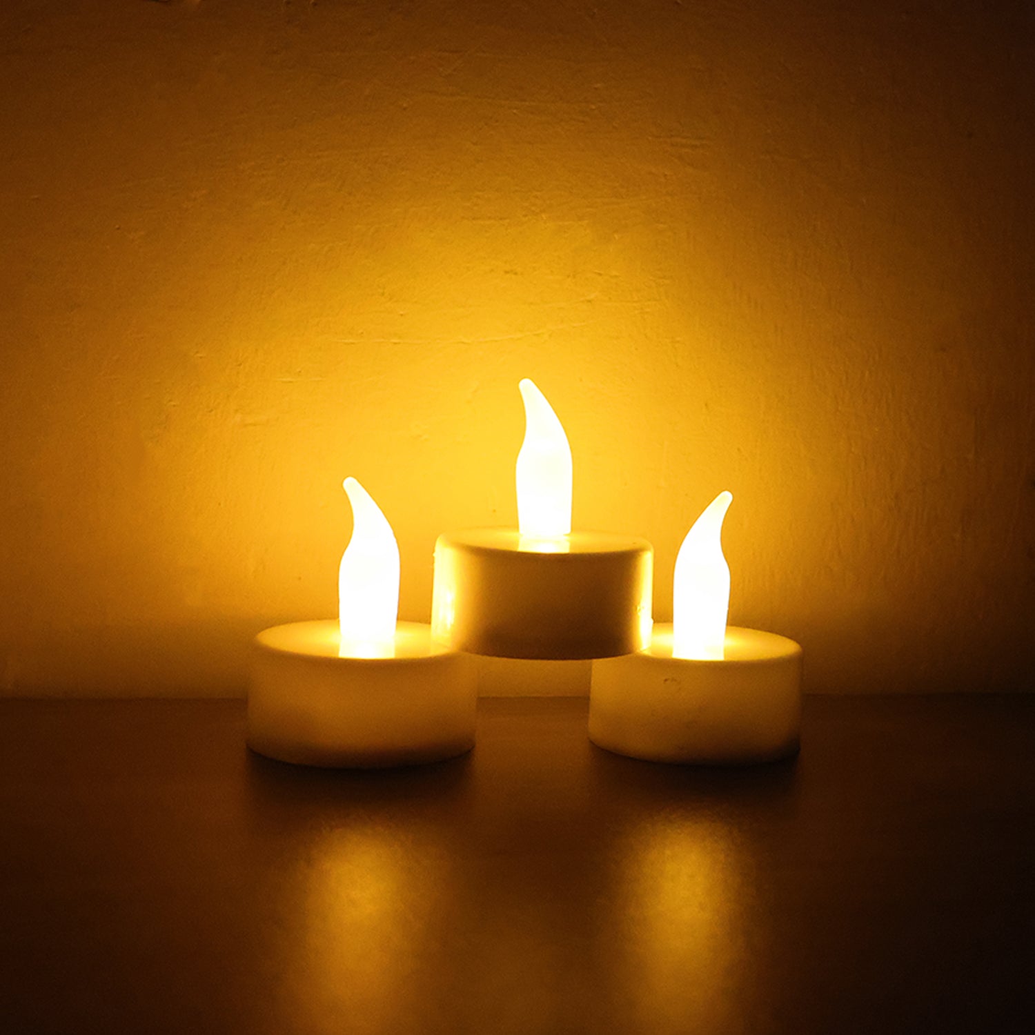 Six Wukusy LED flameless tealight candles for home decor, showcasing warm, flickering light in a cozy setting.