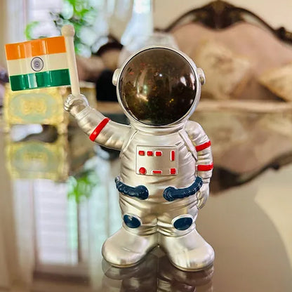Wukusy solar-powered astronaut ornament with moving hand holding Indian flag, ideal for space-themed home decor.