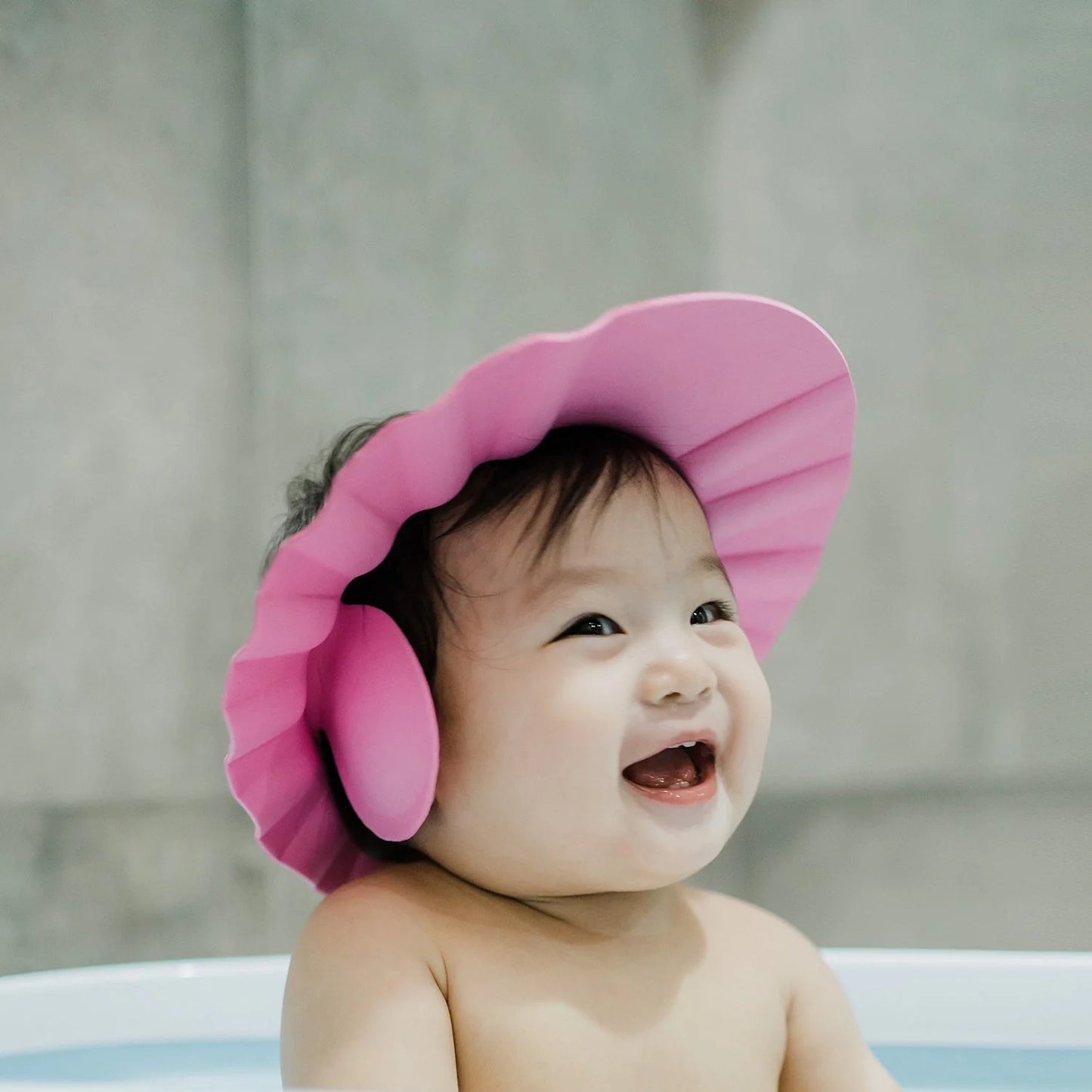 Wukusy adjustable soft baby shower hair wash cap protects eyes and ears during bath for children, made of safe, comfortable material.