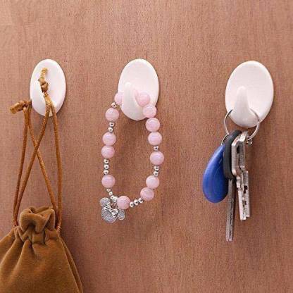 Set of 9 Wukusy self-adhesive plastic wall hooks for home and kitchen, ideal for hanging items in various spaces.