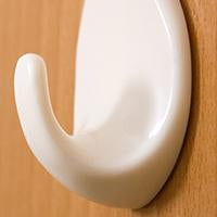 Wukusy 1544 Self Adhesive Plastic Wall Hook Set, 9-pack for home and kitchen organization, mounted on wall for hanging items.