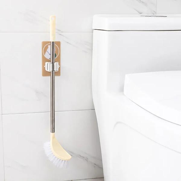 Wukusy Magic Sticker Series self-adhesive mop and broom holder for home organization, mounted on a wall for easy cleaning tool storage.
