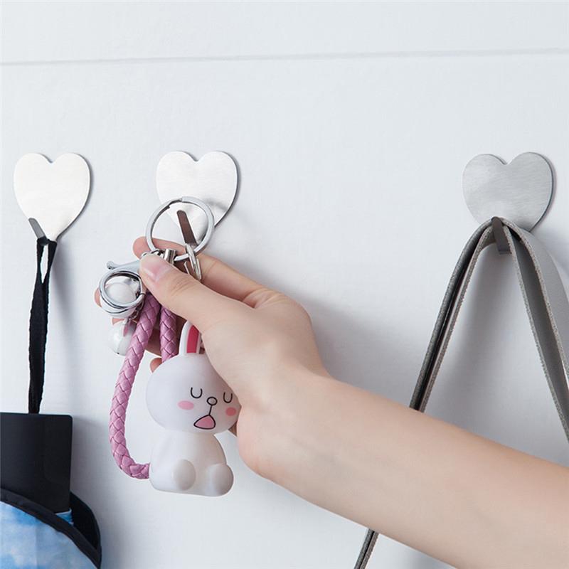 Wukusy 1660 heavy-duty self-adhesive hooks, pack of 3, for home improvement, showing sturdy hooks attached to a wall surface.
