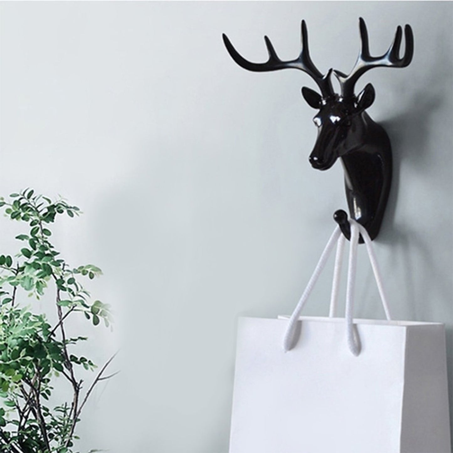 Wukusy 1743 deer head self-adhesive wall door hook hanger for home improvement, mounted on a door with hooks for accessories.