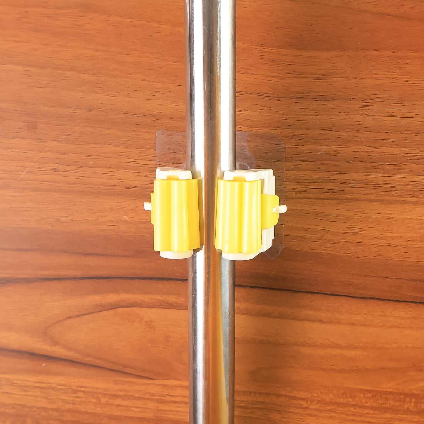 Wukusy Magic Sticker Series self-adhesive mop and broom holder for home organization, mounted on a wall with cleaning tools.