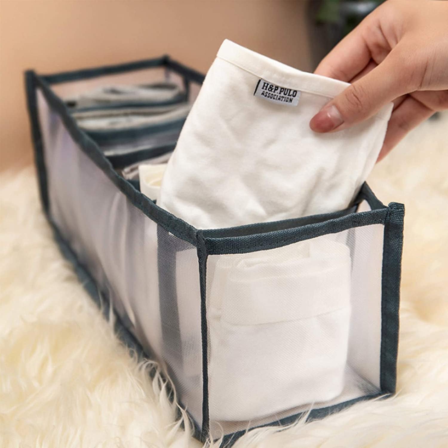 Wukusy Clothes Organizer with 7-grid drawers, foldable wardrobe storage for jeans and clothes in a closet or wardrobe cabinet.