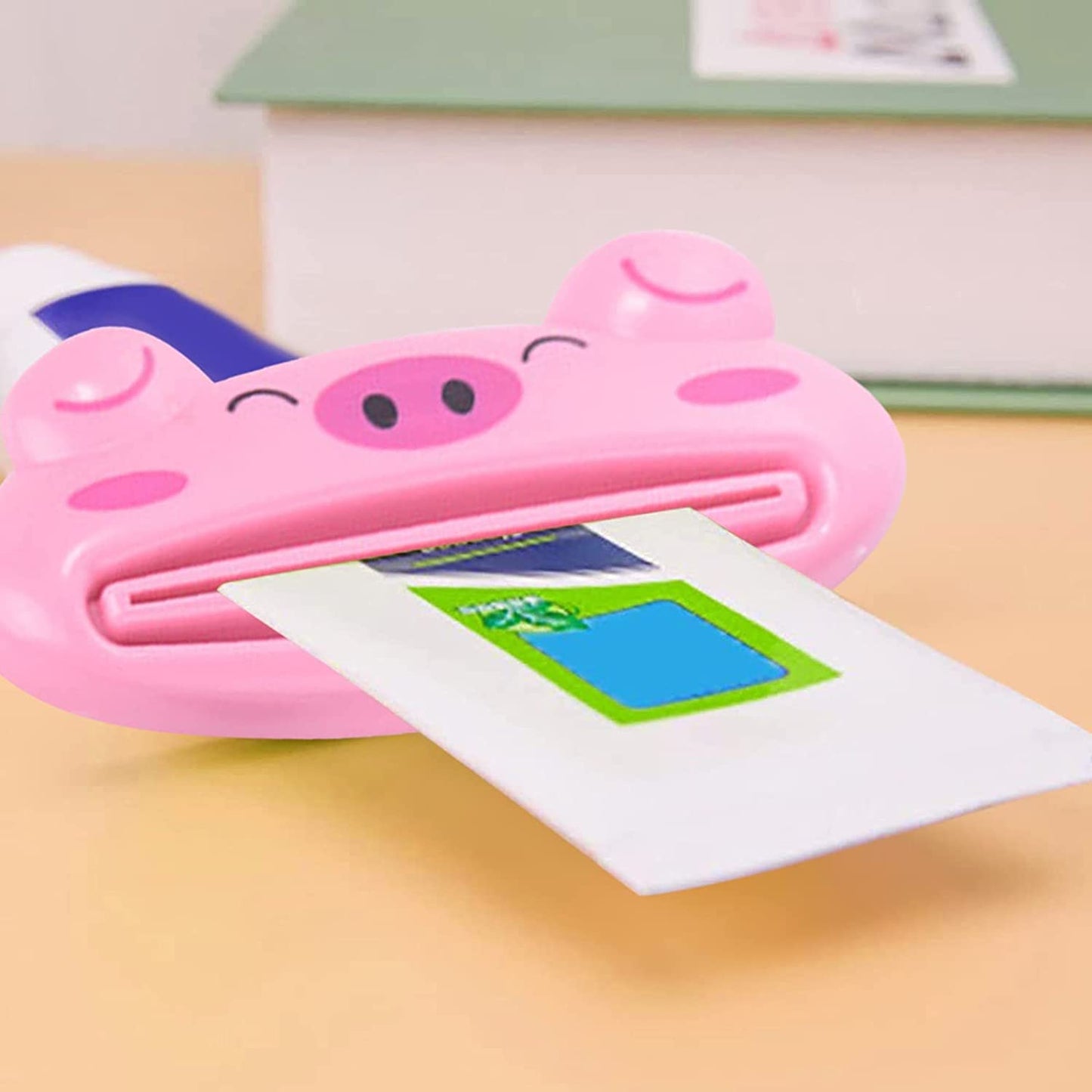 Wukusy 3.5-inch animal-shaped toothpaste tube squeezer for extruding toothpaste, facial wash, and sauce in a home improvement setting.