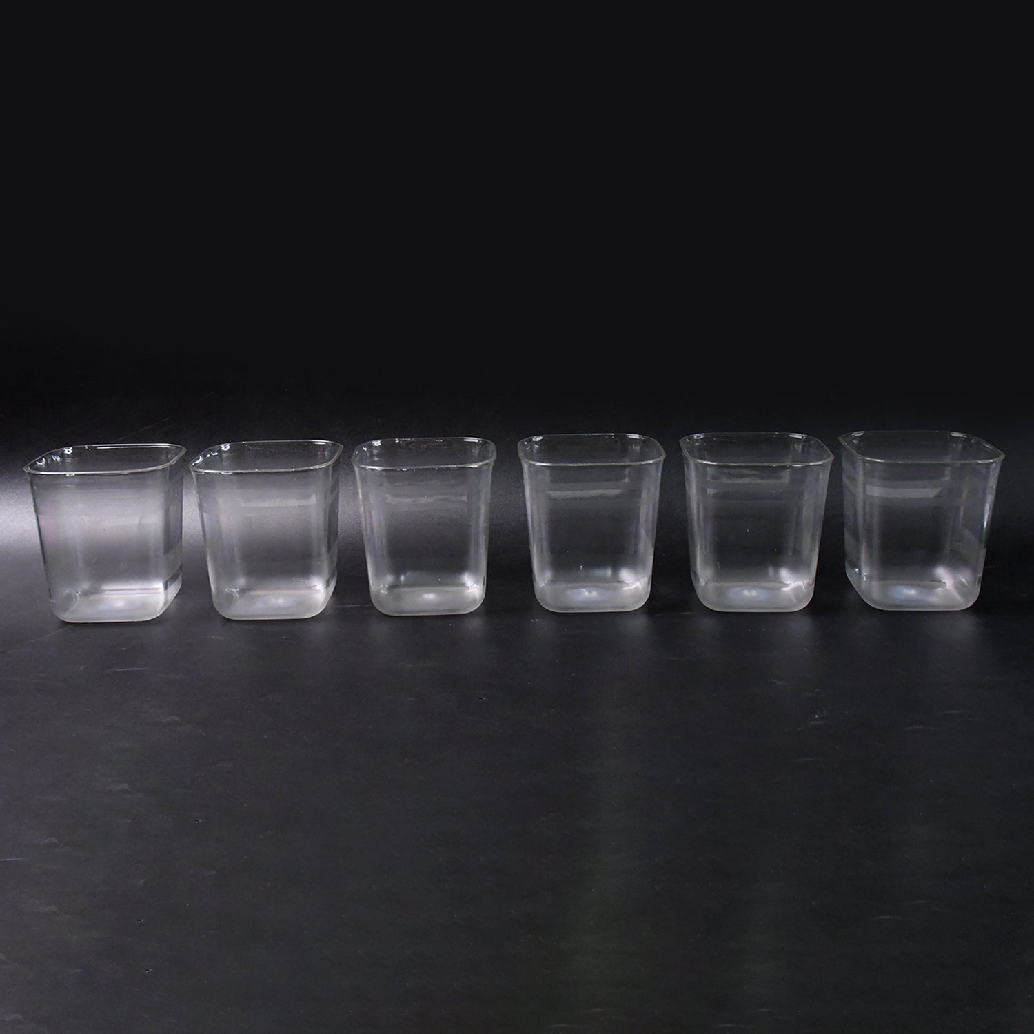 Six transparent diamond-shaped medium serving glasses by Wukusy, ideal for water, juice, and beverages at home.