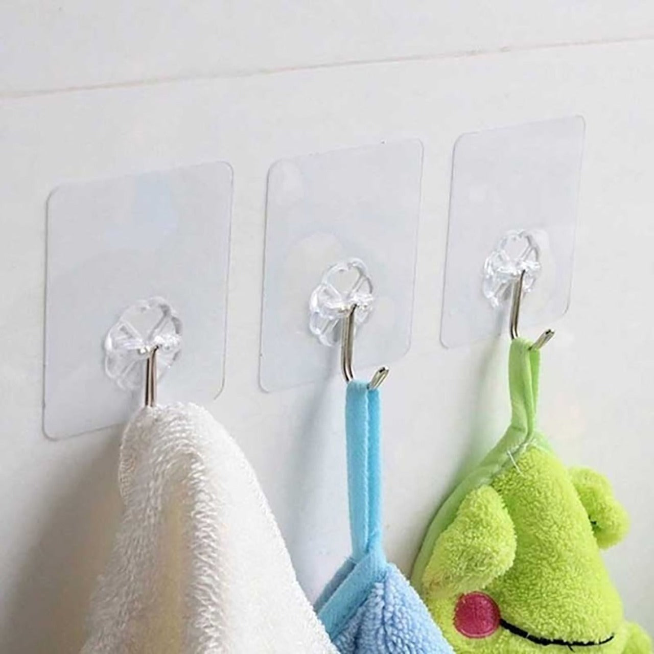 Set of 100 small stainless steel adhesive wall hooks for home improvement, strong and versatile from Wukusy.