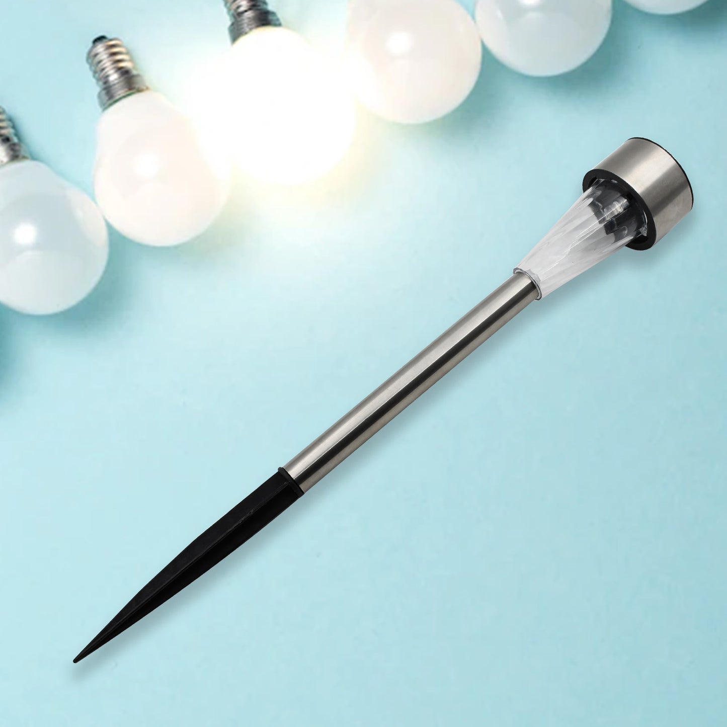 Wukusy solar panel LED spike spot light illuminating garden landscape, pathway, and lawn outdoor lighting for home improvement.