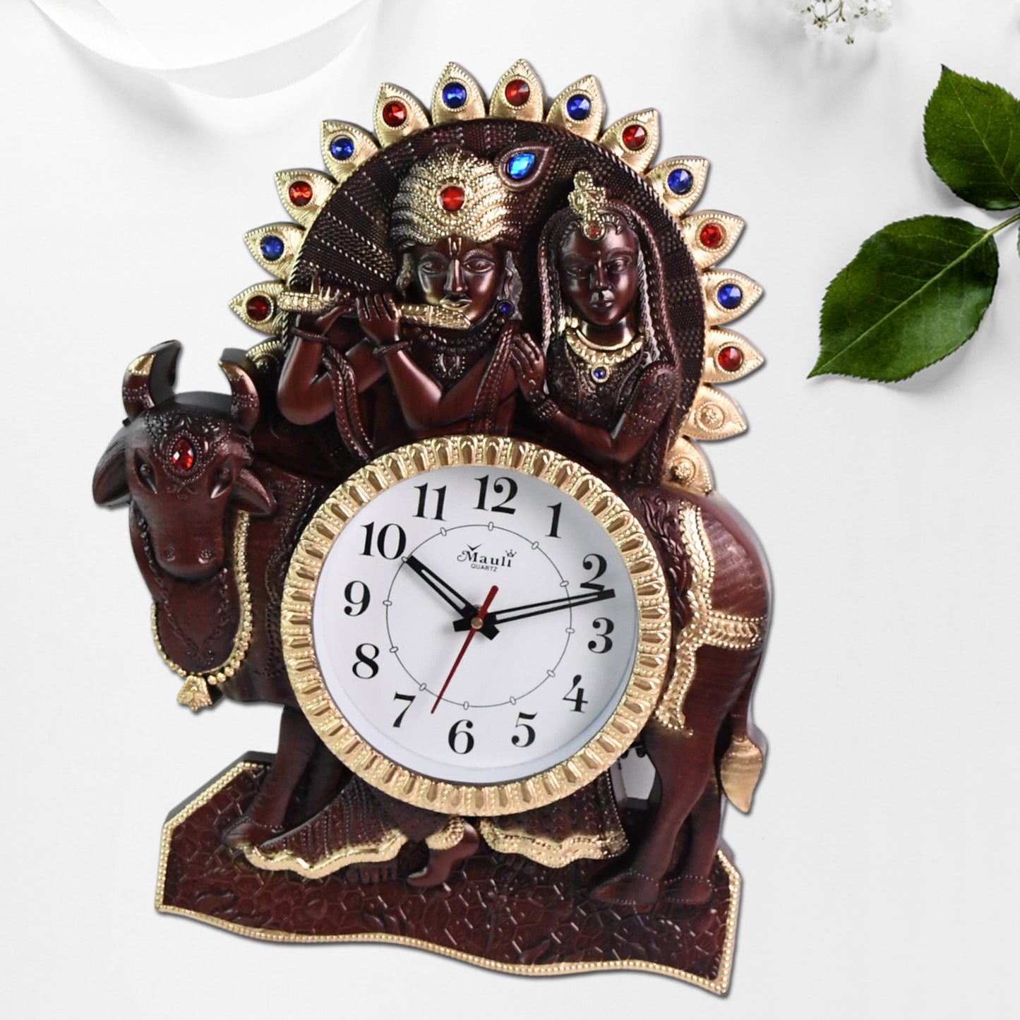 Stylish Wukusy wall clock with Radha Krishna frame, featuring an analog design for home decor and timekeeping.