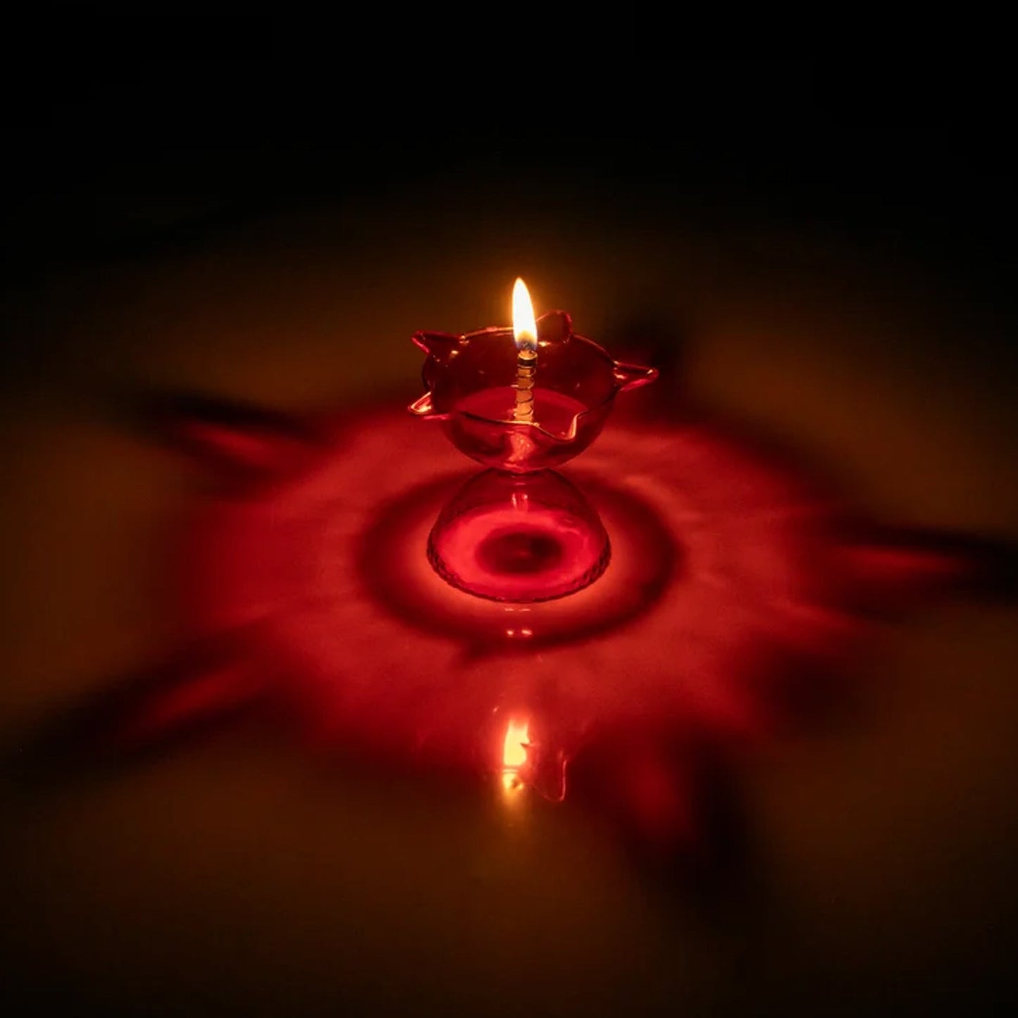 Set of four colorful plastic Diya candle cups with multi-shape designs for home decor by Wukusy.