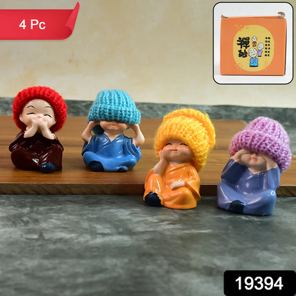 Set of four decorative resin Monk Buddha showpieces with traditional straw hats, ideal for home decor and improvement.